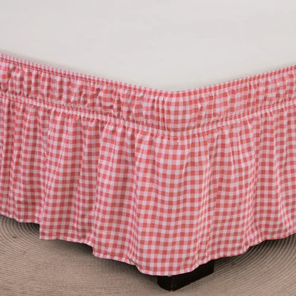 Pink and white gingham bed skirt with ruffled hem featuring diamond lattice ruffled design and elastic band closure