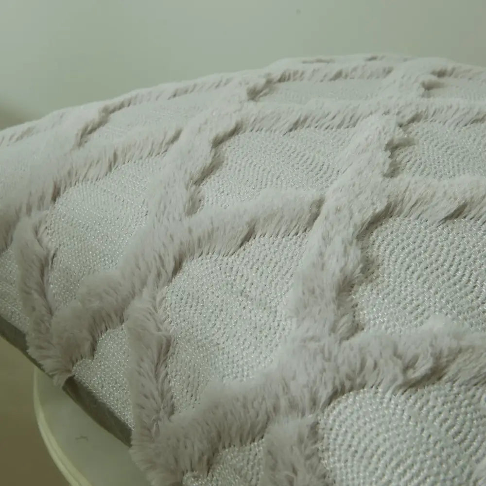 A plush light gray throw blanket with diamond solid embroidery cushion cover and textured soft fuzzy border