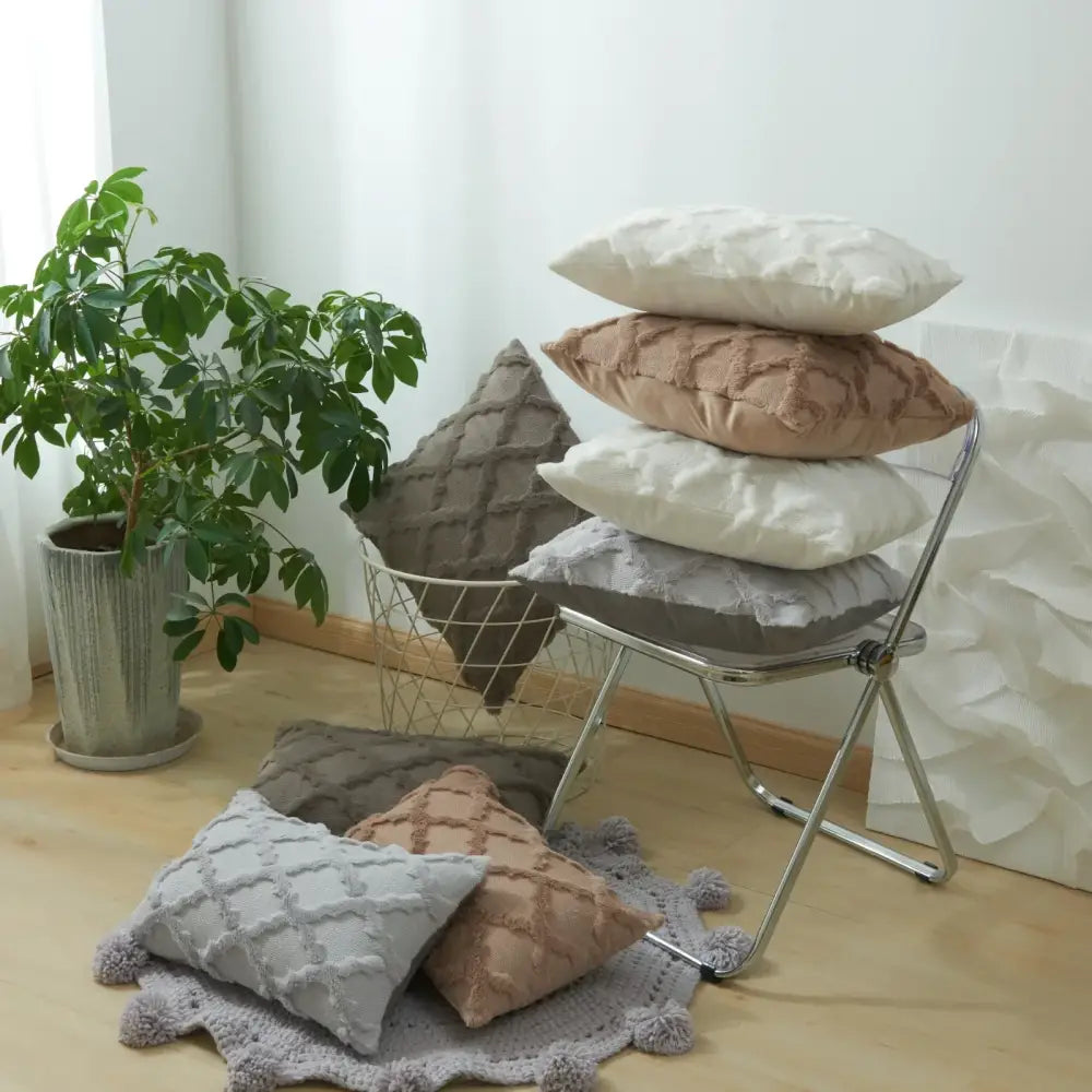 Stack of neutral tone cushion covers with diamond solid embroidery and quilted textured fabric for living room use