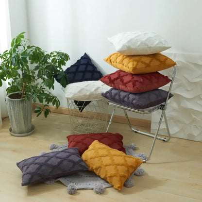 Stack of quilted throw pillows in mustard yellow deep red navy blue and white with diamond solid embroidery cushion covers