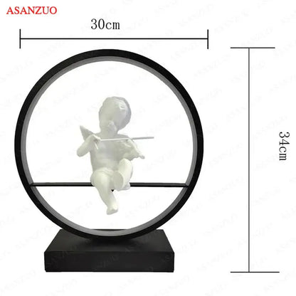 Dimmable angel table lamp featuring a white cherub figurine seated in a black circular frame on a matching base