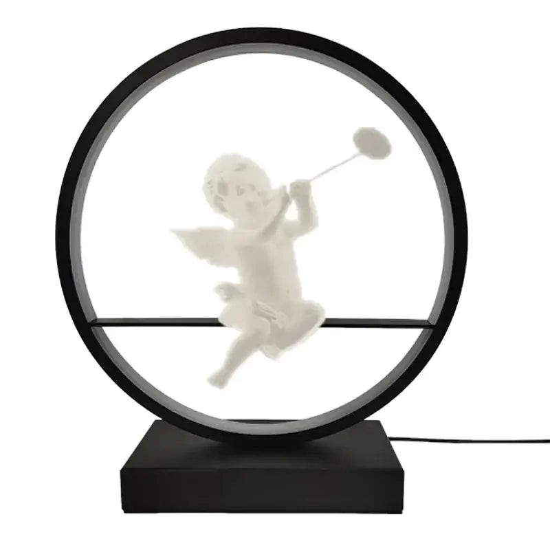 Dimbable angel table lamp featuring a white cherub figurine suspended in a black circular frame with led lighting