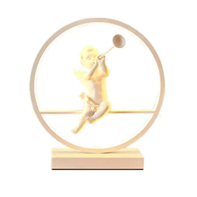 Glowing dimmable angel table lamp with golden figurine and white cherub for bedroom decor by decorbites