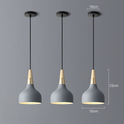 Gray concrete pendant light with brass accents and black cord in modern design for dining room chandelier use