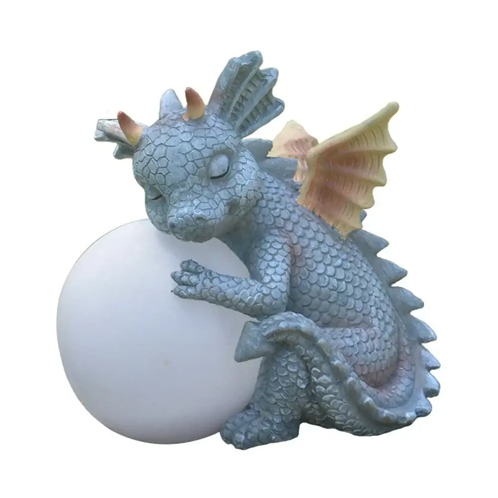 A serene light blue dino garden sculpture with peach wings cradling a white orb perfect for outdoor decorbites dino garden fun dinosaur decor