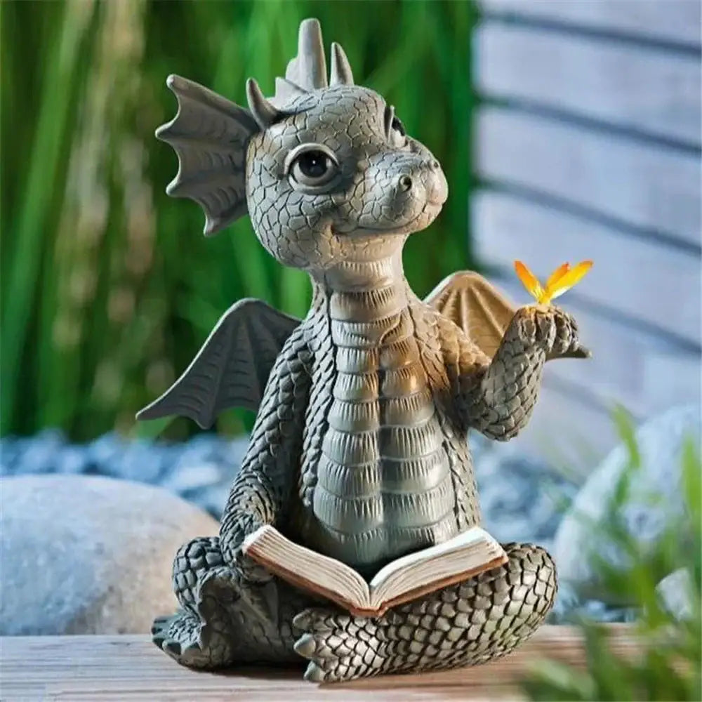 A charming gray resin dino garden sculpture gray dragon figurine with detailed scales holding an open book for decorbites dino garden fun dinosaur decor