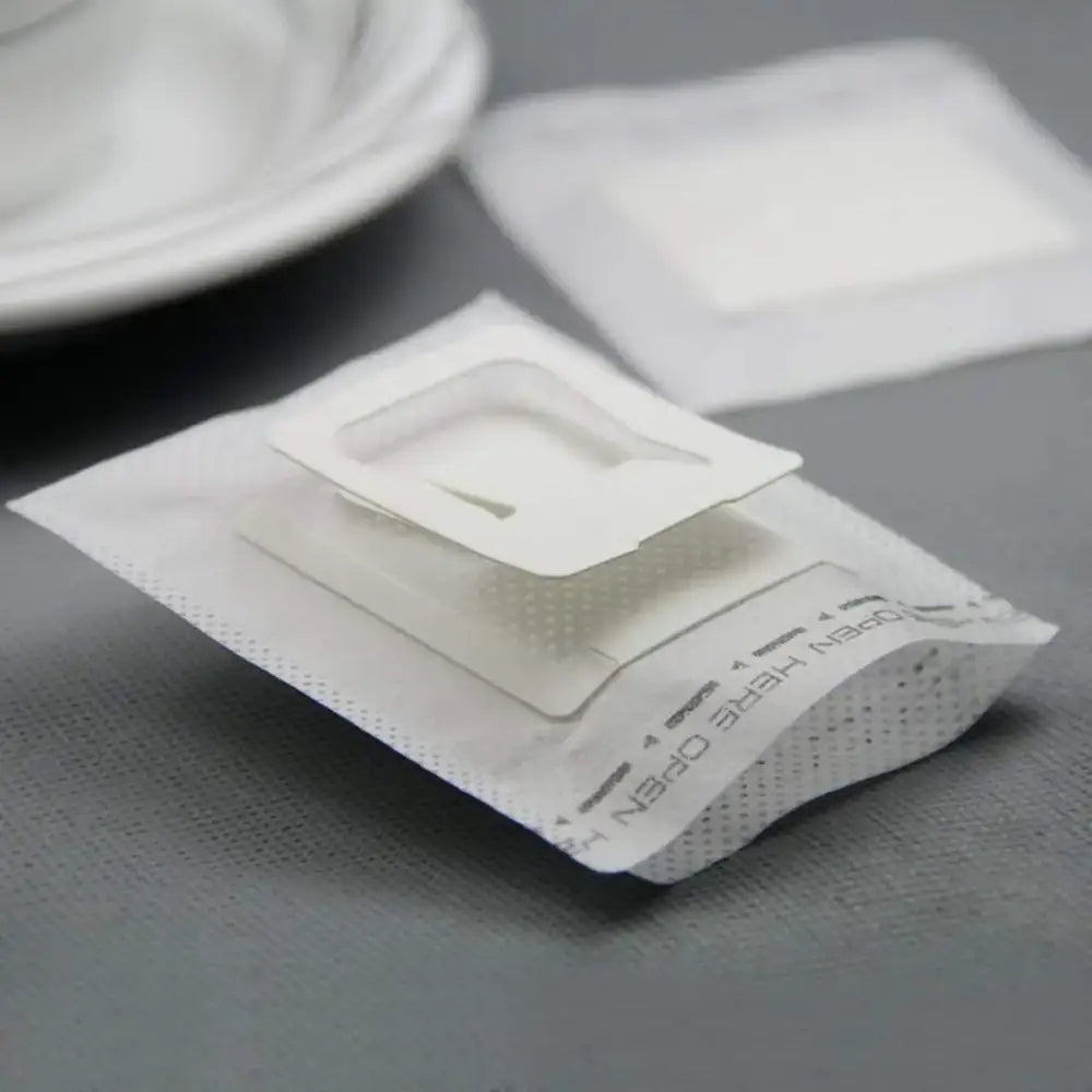 Disposable coffee filter cup with white paper bag, clear plastic insert, and perforated edges for filter cup drip use