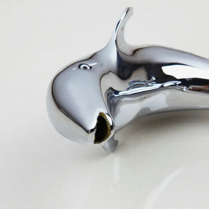 Shiny chrome dolphin shape bottle opener with sleek reflective surface complementing decorbites dolphin shape faucet
