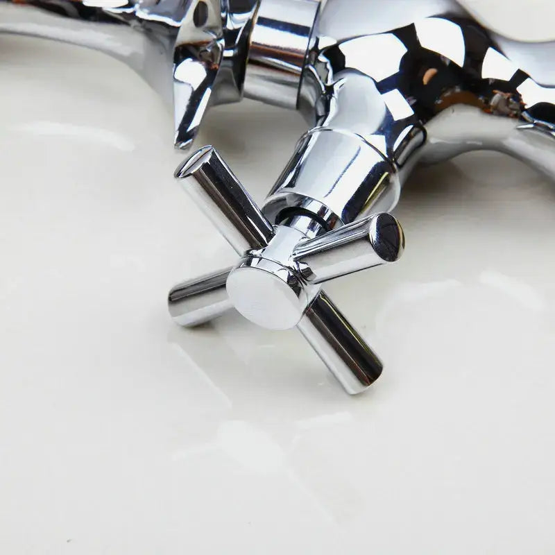 Chrome finished decorbites dolphin shape bathroom faucet with dual cross handles and a sleek reflective metallic finish