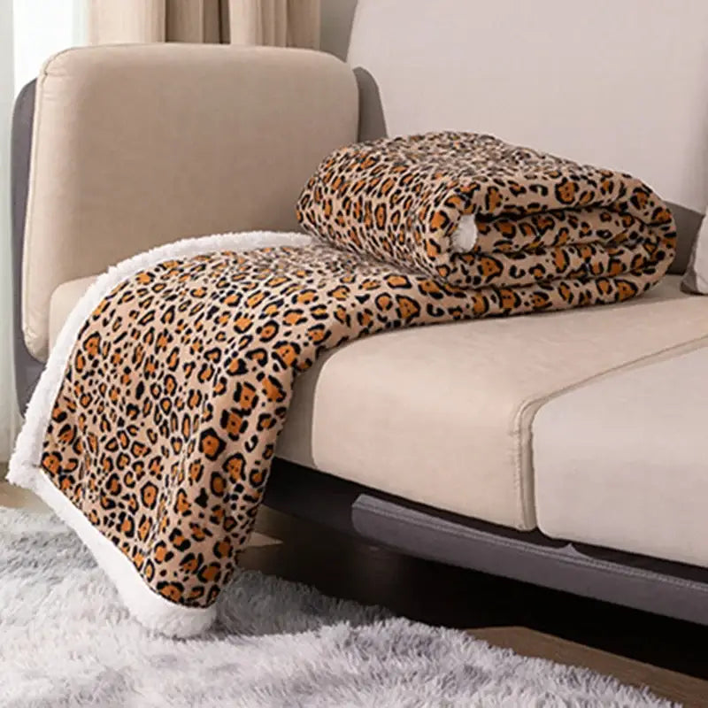 Cozy double layer leopard print coral fleece blanket with beige base orange brown spots and white fleece lining