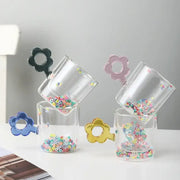 Double wall glass mugs featuring clear tumblers with glitter flowers in black pink blue and gold for kitchen use