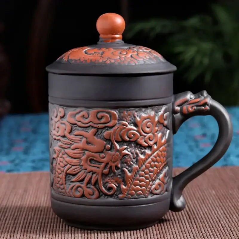 Dark brown ceramic dragon phoenix thermo coffee mug with intricate orange-brown relief carvings and matching lid with wooden knob