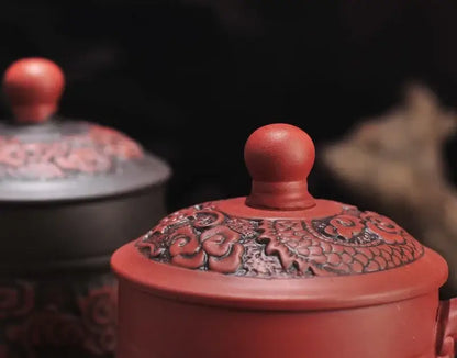 Red ceramic dragon phoenix thermo coffee mug with intricate floral and dragon motifs and rounded knob lid