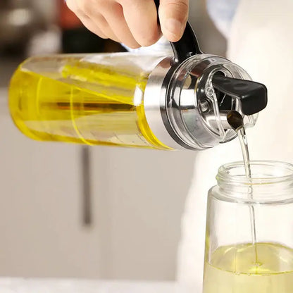 Durable automatic oil bottle in clear glass with black handle and silver cap filled with golden-yellow cooking oil for kitchen storage