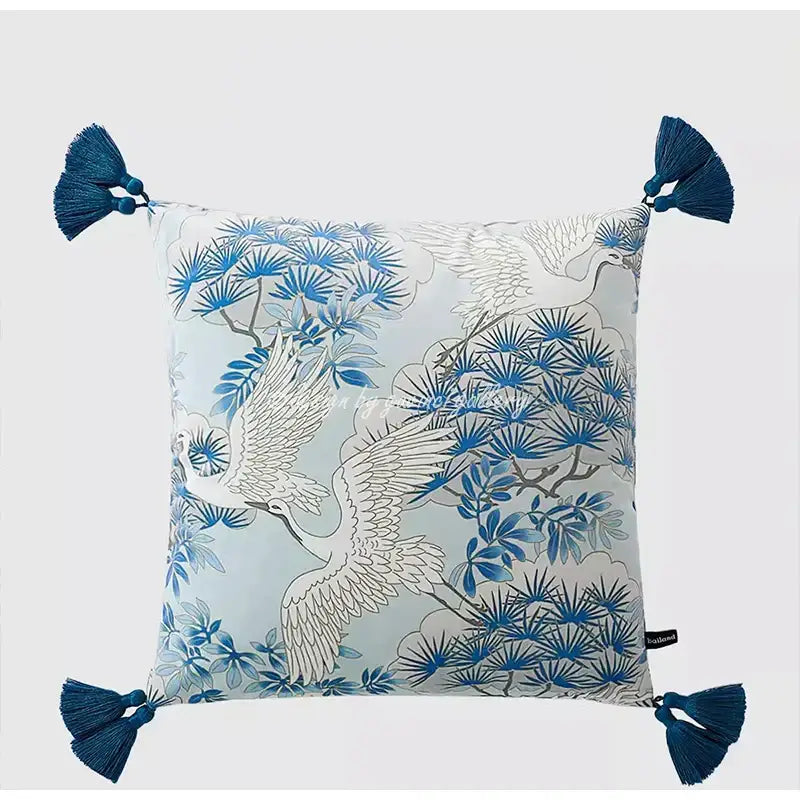 Eclectic indigo blue pillow cover with crane and pine pattern on light gray fabric accented with deep blue tassels decorbites indigo blue