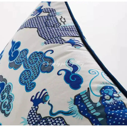 A triangular cream pillow cover featuring an intricate indigo blue dragon motif for decorbites indigo blue decor