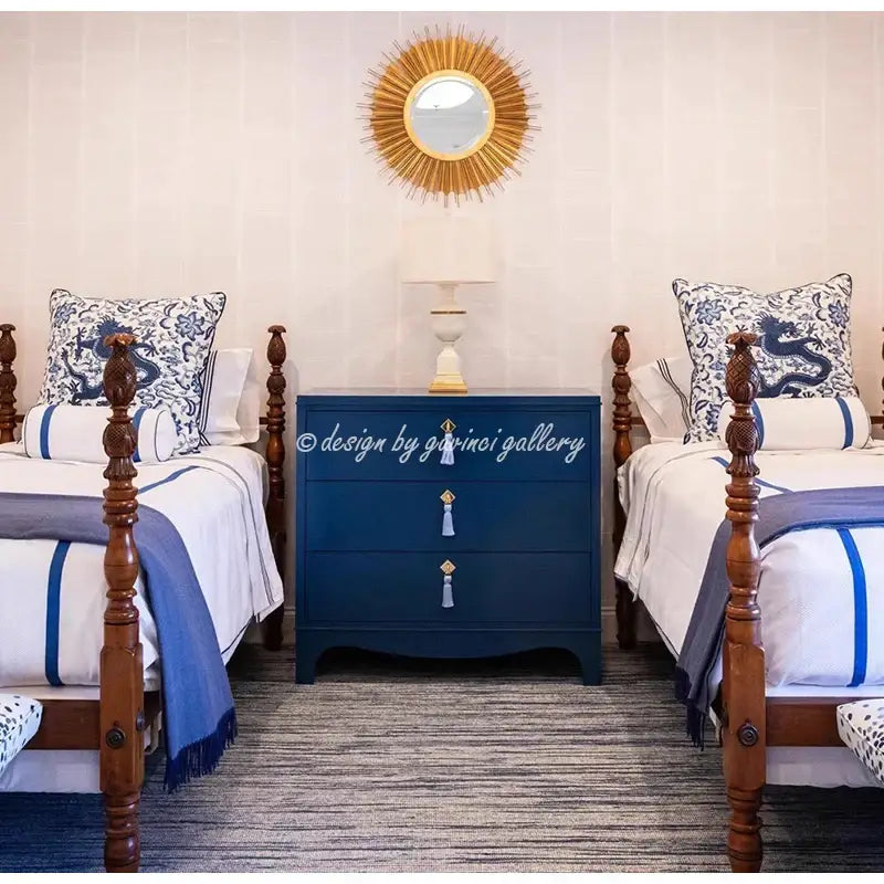 Navy blue three-drawer dresser with gold tassel pulls beneath a sunburst mirror complements decorbites indigo blue pillow cover decor