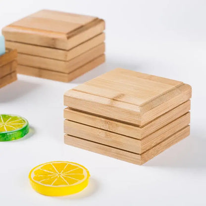 Stacks of light brown bamboo coasters with natural wood grain finish for eco-friendly bamboo soap dish and storage rack