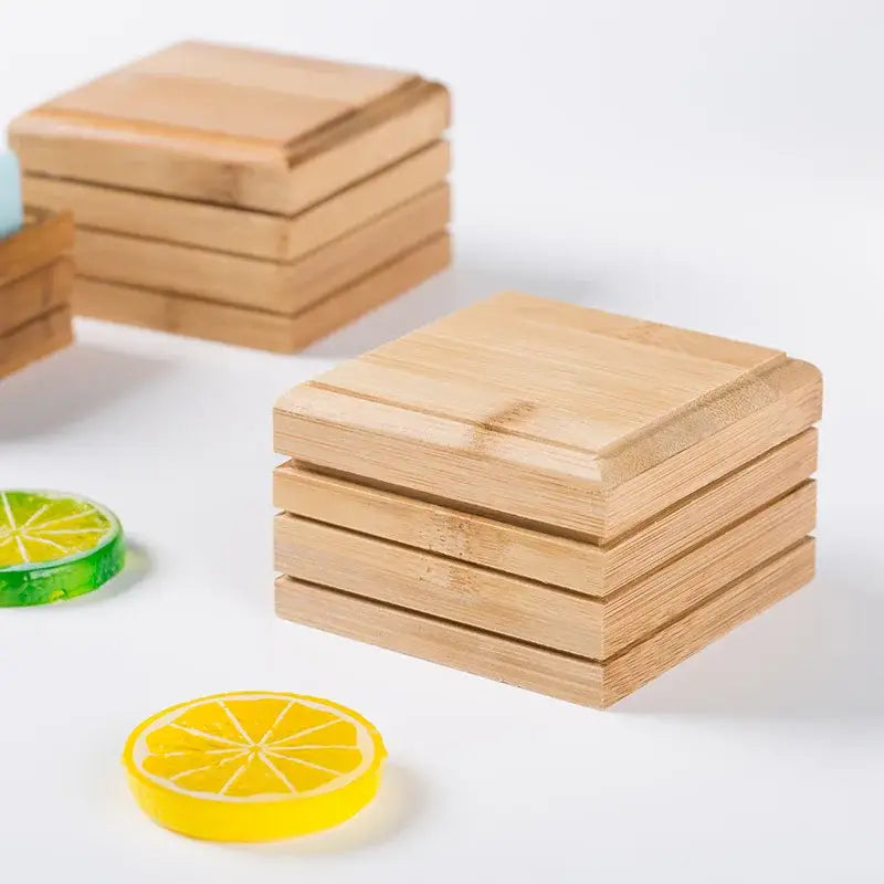 Stacks of light brown bamboo coasters with natural wood grain finish for eco-friendly bamboo soap dish and storage rack