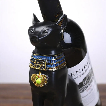 Egyptian cat black and gold wine bottle holder with eye symbol and green gemstone pendant for dining room decor