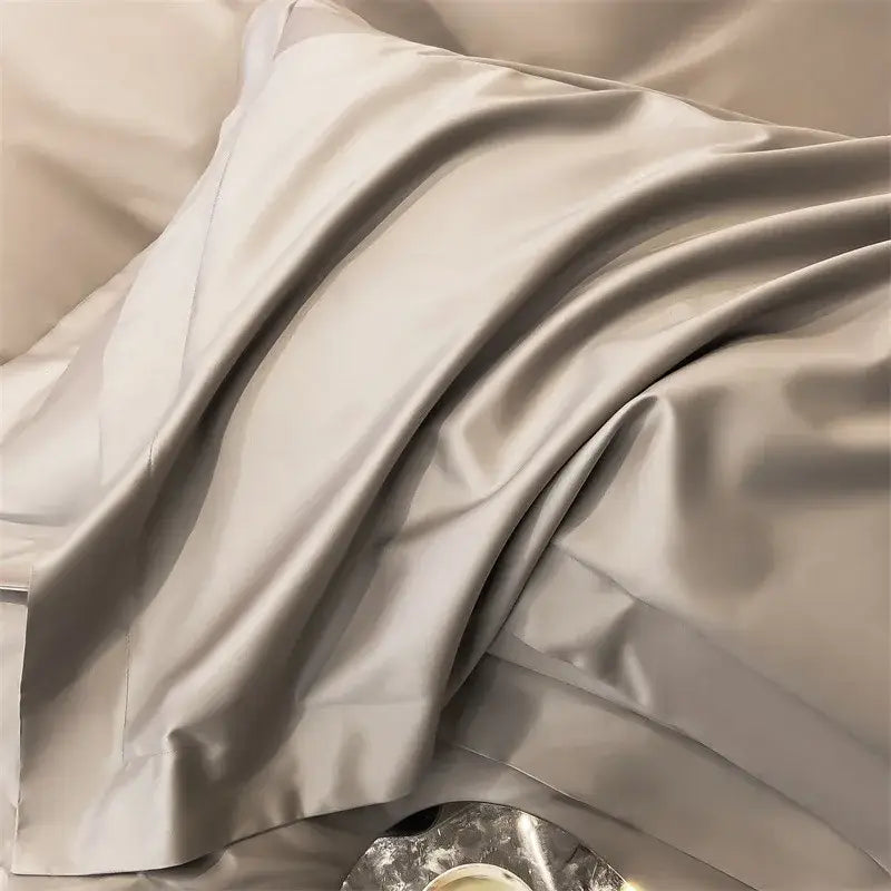 A luxurious silver-gray satin pillowcase from DecorBites™ 1000TC Egyptian cotton bedding set with duvet cover and fitted sheet