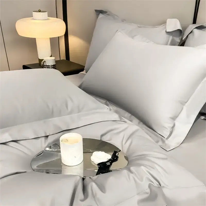 A sleek metallic tray with a white candle complements the DecorBites™ 1000TC Egyptian cotton duvet cover set