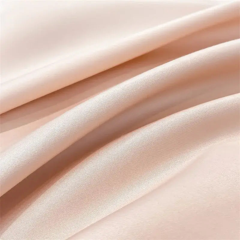Soft peach-colored satin decorbites™ 1000tc egyptian cotton duvet cover with smooth glossy finish and subtle sheen