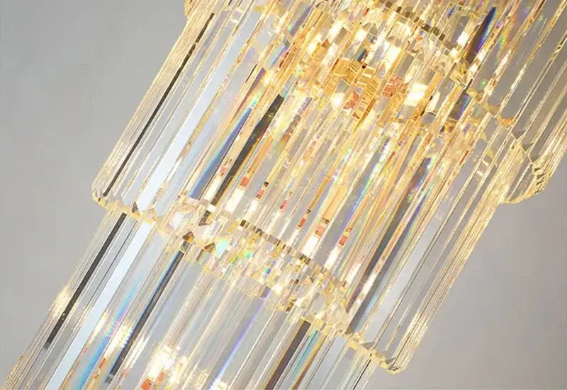 An elegant amber and clear crystal led pendant chandelier with cascading prisms refracting vibrant rainbow hues for dining room decorbites crystal led