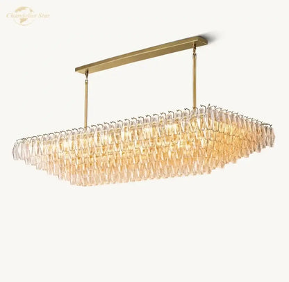 Elegant amber clear glass tiered chandelier with gold-toned rectangular frame and cascading clear glass prisms decorbites clear glass