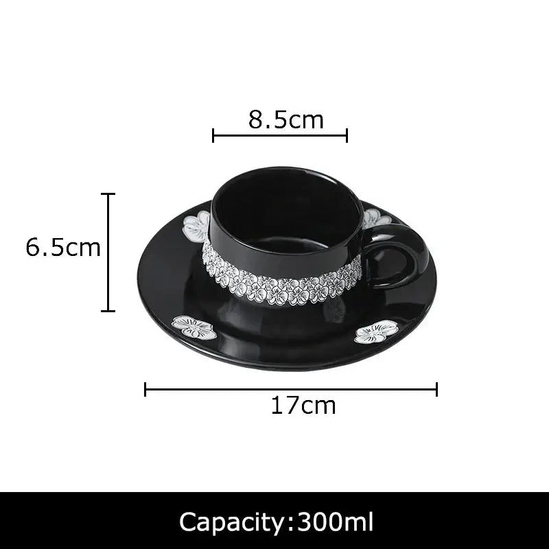 Elegant black porcelain cup and saucer set with silver and white floral embellishments for dining room use