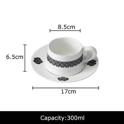 Elegant black and white floral porcelain cup and saucer set featuring delicate patterns for dining room use