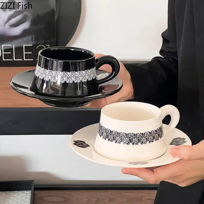 Elegant black porcelain cup and saucer set with silver floral band perfect for dining room use