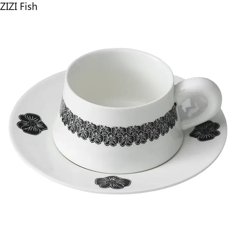 Elegant black and white floral porcelain cup and saucer set featuring a delicate pattern for dining room use