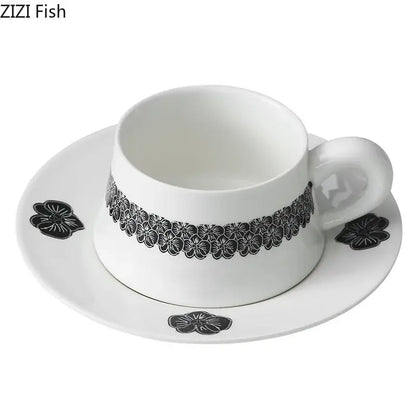 Elegant black and white floral porcelain cup and saucer set featuring a delicate pattern for dining room use