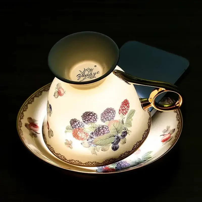 A cream porcelain teacup with gold trim and vibrant hand-painted berry decorbites fruits pattern ceramic tea set