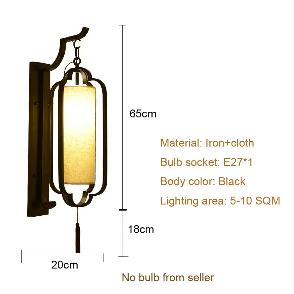 Elegant black wrought iron wall sconce lamp with a rectangular lantern-shaped shade and tassel for bedroom lighting