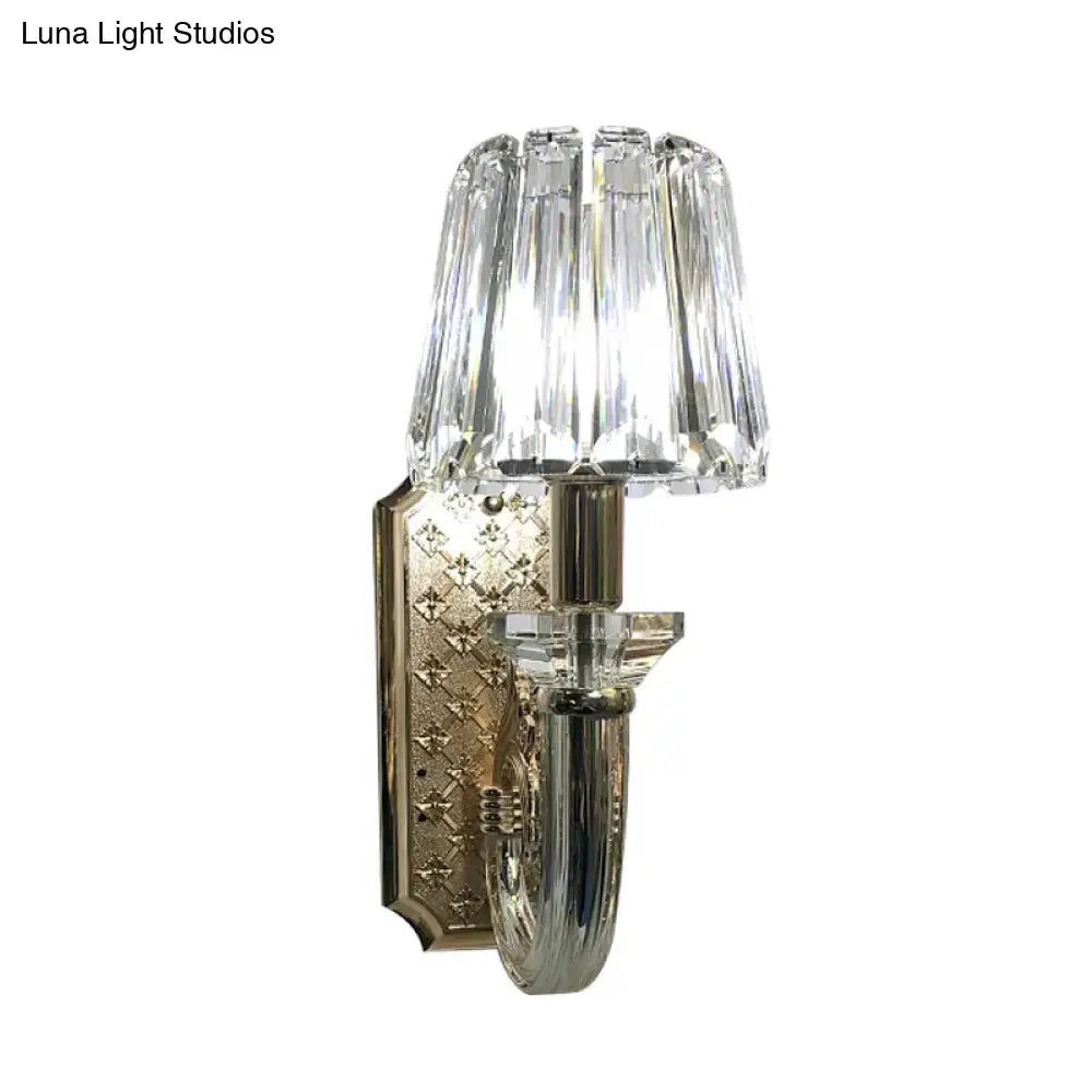 Elegant brass and crystal tapered cone sconce light with faceted glass shade and embossed diamond mounting plate for bedroom