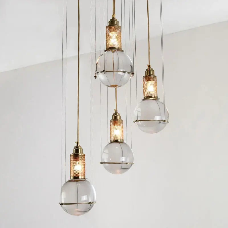 Elegant brass crystal ball pendant lights with clear glass globe shades and mesh detailing for dining room decorbites crystal ball led