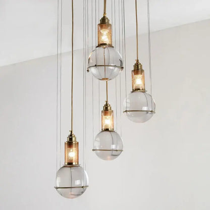Elegant brass crystal ball pendant lights with clear glass globe shades and mesh detailing for dining room decorbites crystal ball led