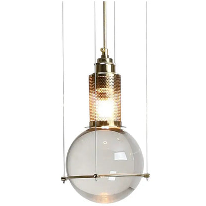 A modern brass pendant light with translucent glass globe and perforated shade for elegant dining room decorbites crystal ball led