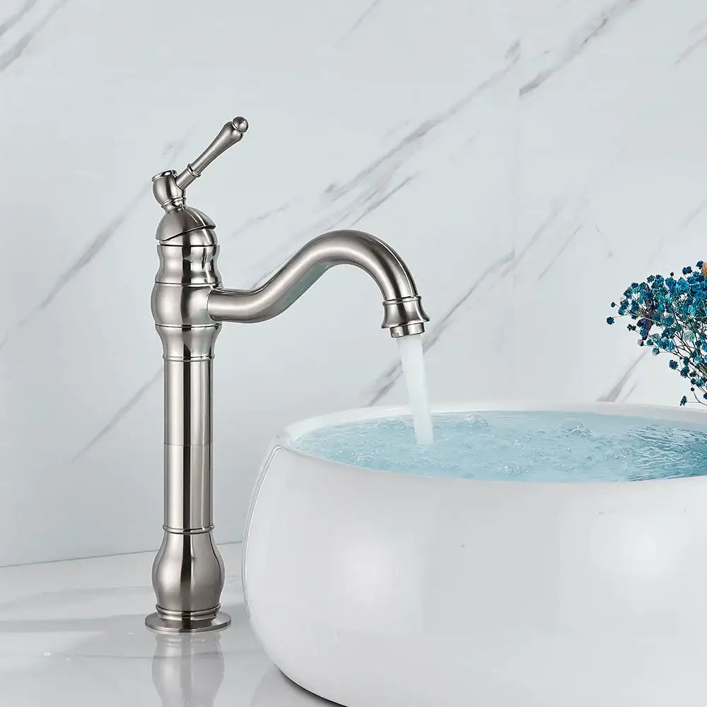 Elegant brushed nickel single handle sink faucet with a curved spout and decorative ridged base for bathroom use