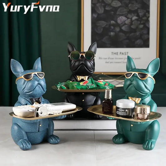 Three elegant bulldog figurine coin banks in blue black and teal with gold rims serve as stylish home decor trays