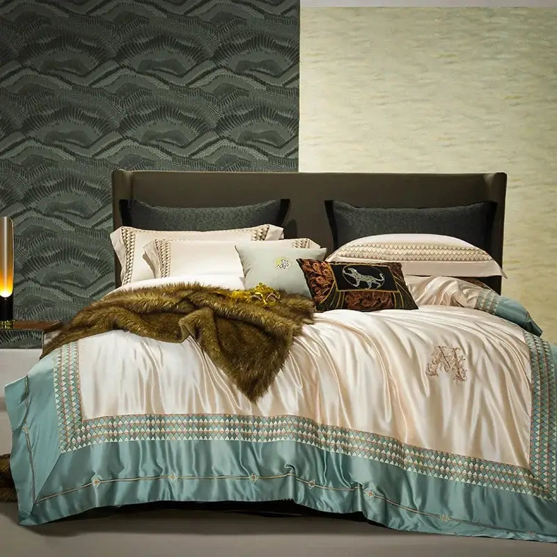 Cream-colored satin duvet cover with teal border and monogram in decorbites 1200tc egyptian cotton bedding set