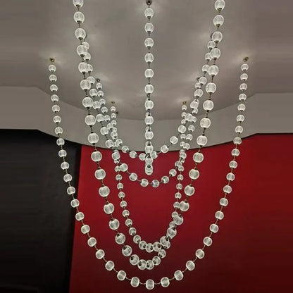 A modern crystal and gold staircase chandelier with cascading clear faceted glass beads elegant pendant lights decorbites
