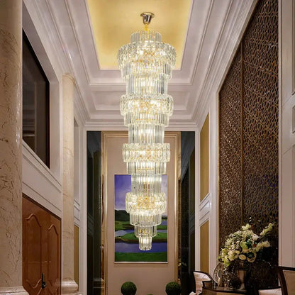 Elegant crystal hollow gold chandelier with cascading cylindrical glass elements and warm glowing lights for stairwell decorbites elegant crystal