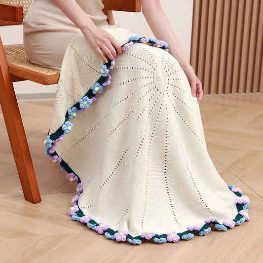 Cream-colored knitted elegant daisy bouquet soft blanket with crocheted purple blue and yellow flowers decorbites elegant daisy