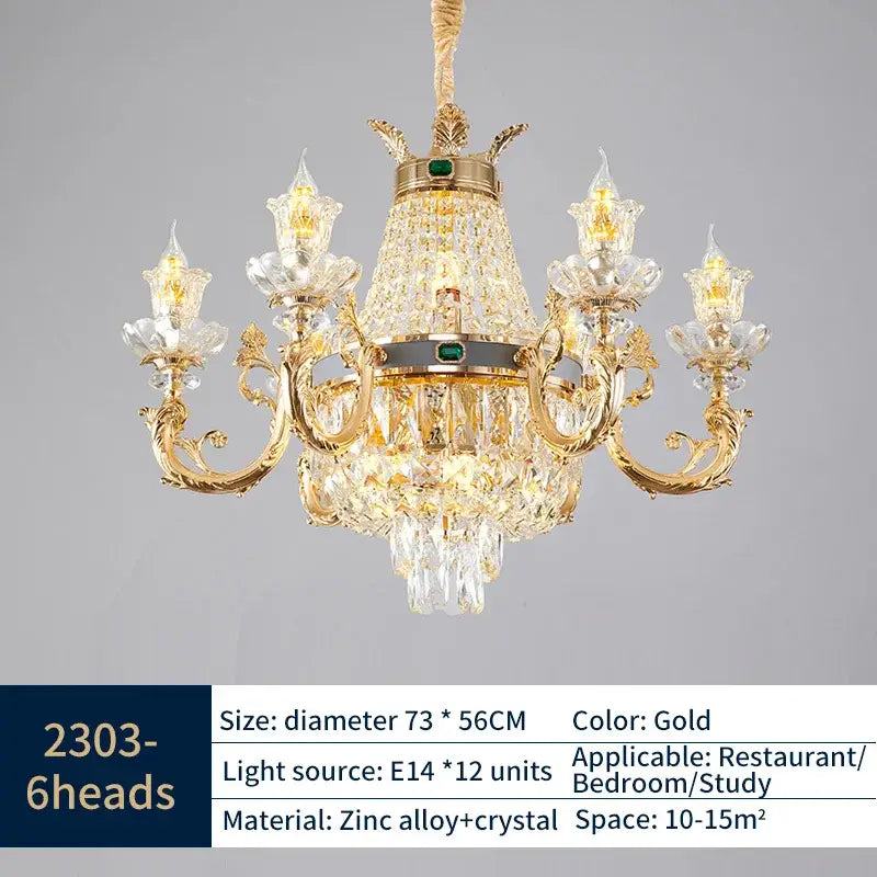 Elegant duplex crystal gold chandelier with ornate arms, intricate crystal droplets, and central green gemstone accent