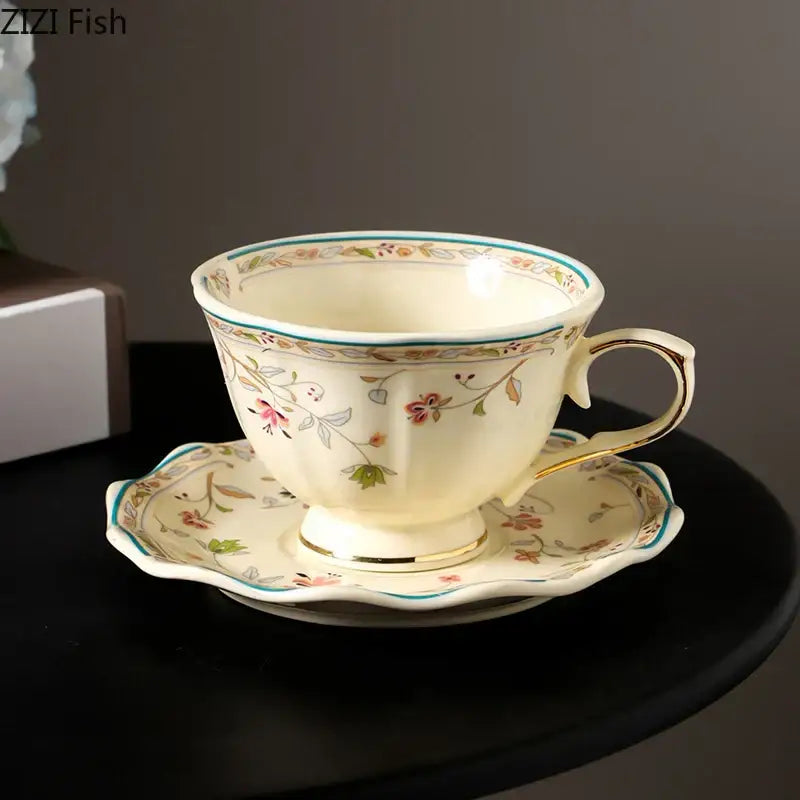 Cream-colored elegant floral ceramic cup and saucer set with pink green and gold accents for dining room use