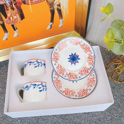 Elegant bone china tea cup set with white ceramic, blue floral patterns, coral-red borders for dining room use