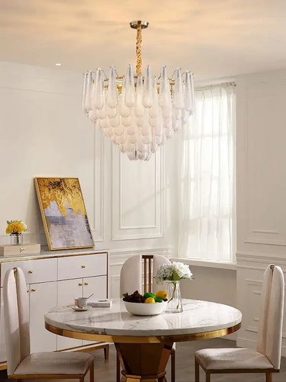 A decorbites elegant glass chandelier with gold tiered metal frame and teardrop glass shades for dining room lighting